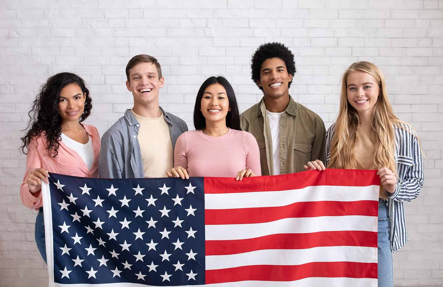 US DACA immigration teens holding USA flag